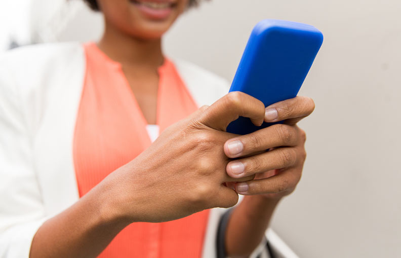 Businesswoman holding a blue mobile phone. 